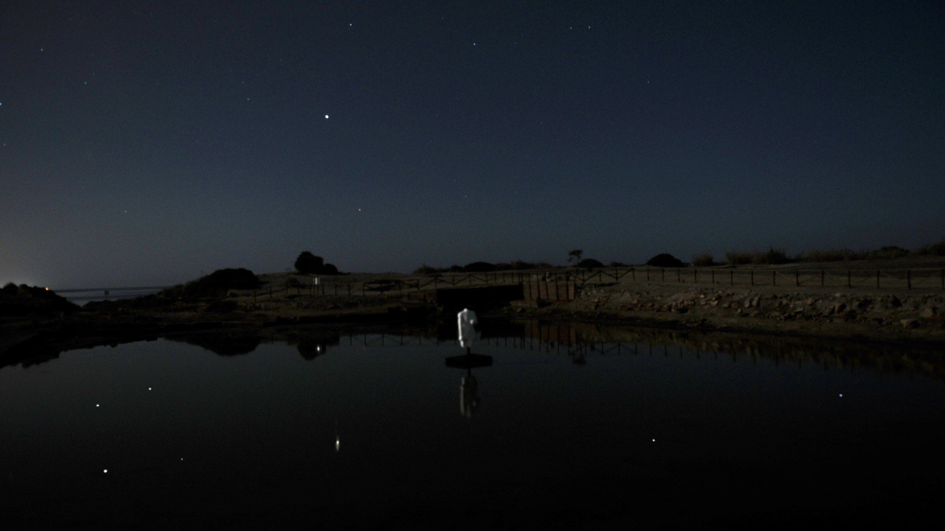 The refilled pool reflects the stars of the modern night sky.
