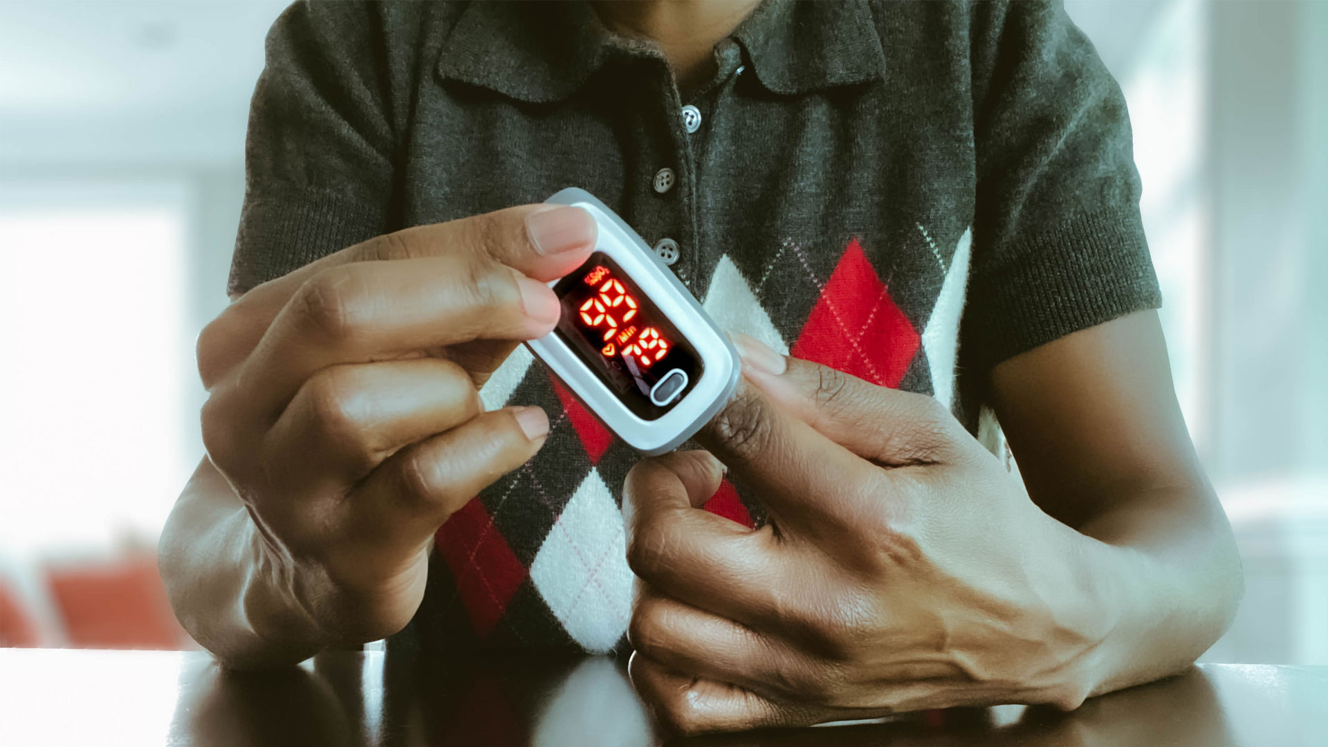 How do we know when blood oxygen is too low? Image shows man with blood exygen test