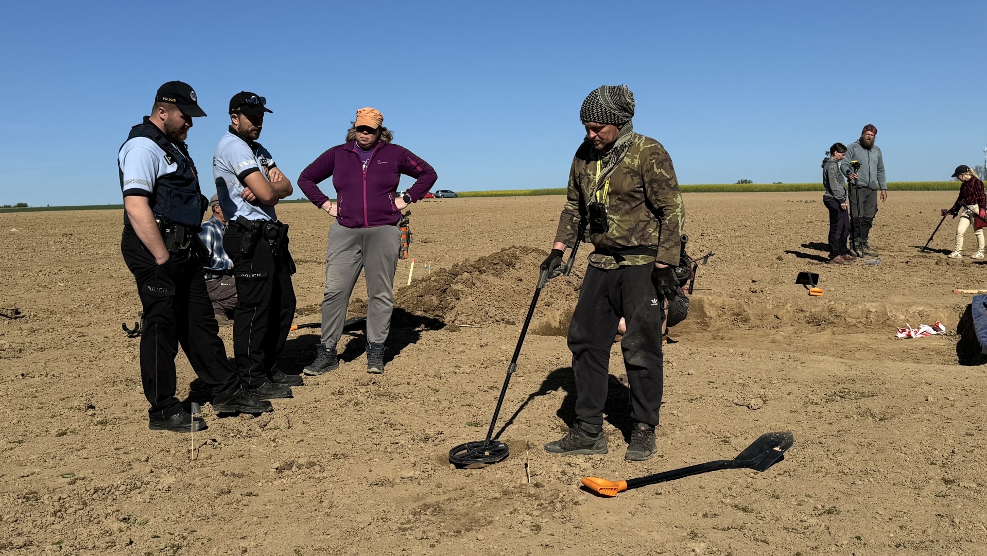 man checking dirt for metal with metal detectors