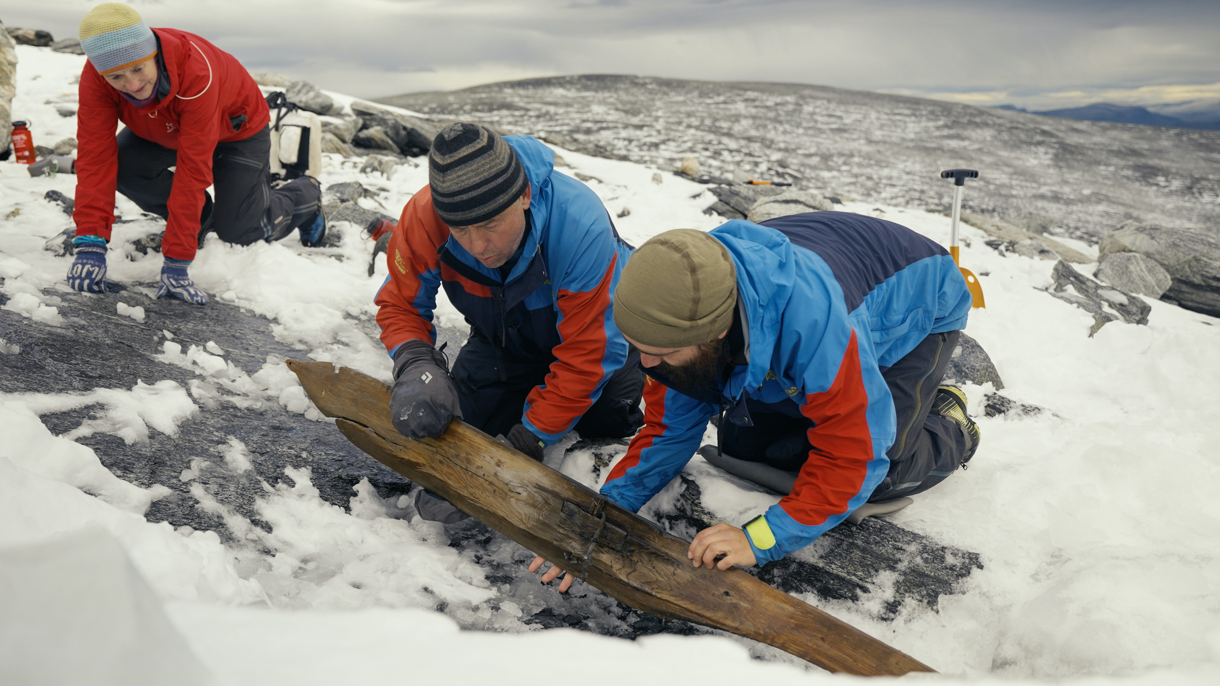 Archaeologists turn the ski. Notice the upside with the raised foothold and binding.
