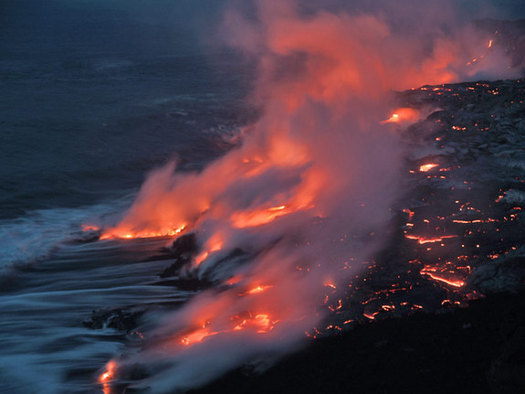 Lava from a 2004 eruption at Mt. Kilauea flows into the ocean. Lava emits toxic gases, and, when combined with seawater, it can form mists of corrosive hydrochloric acid.