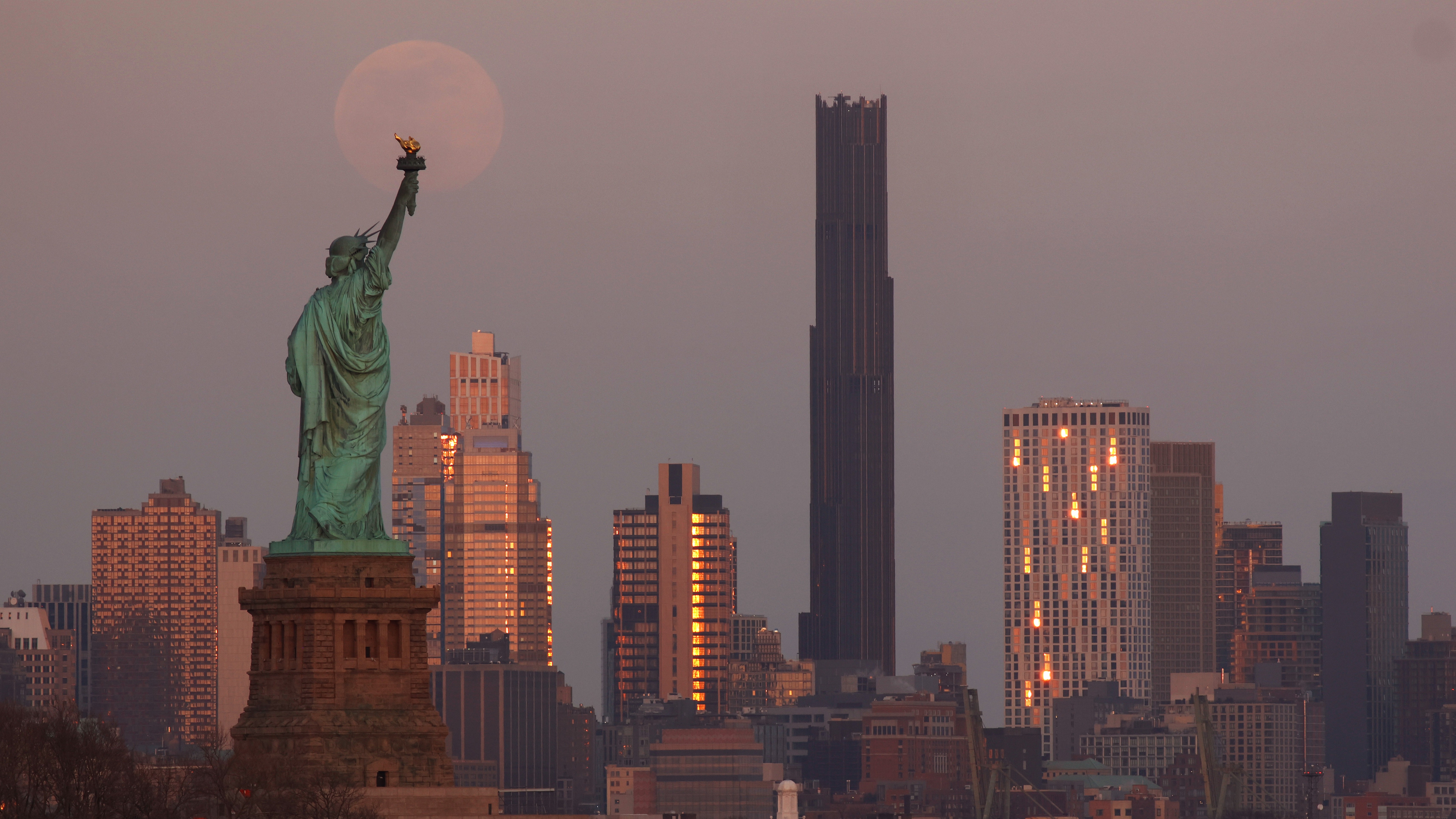 A photo of the &lsquo;blood moon&rsquo; hovering above the Statue of Liberty in New York.