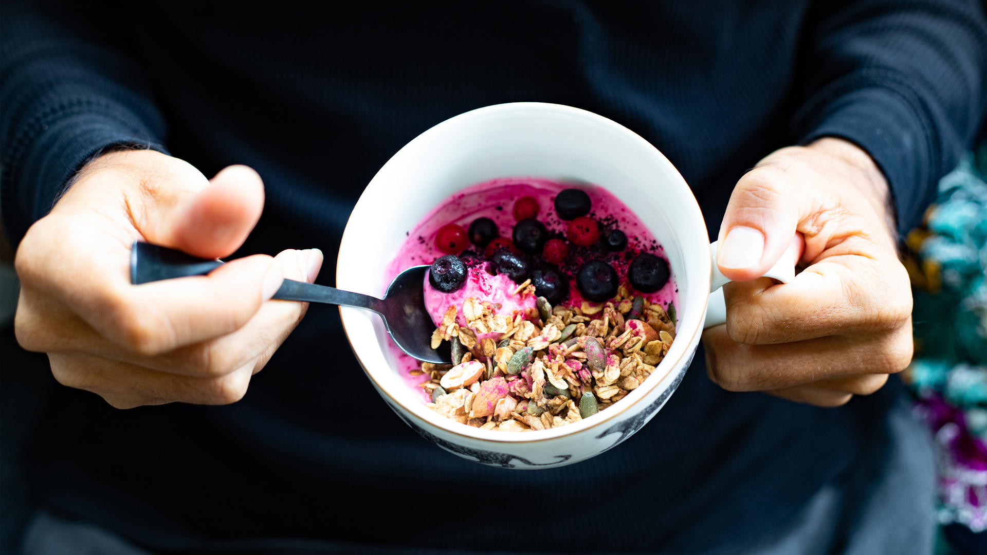 man eating an acai bowl