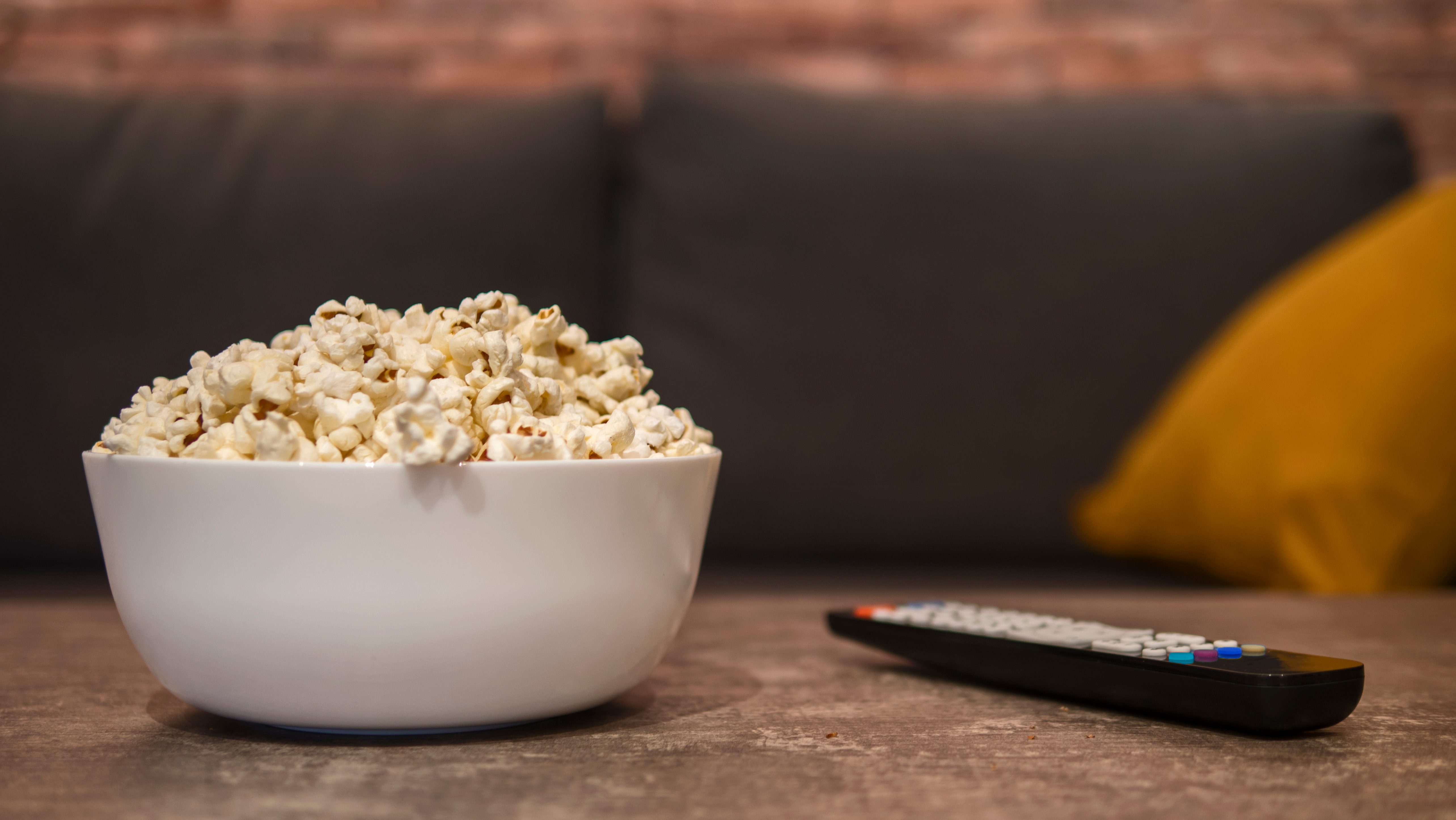 A bowl of popcorn on a coffee table.