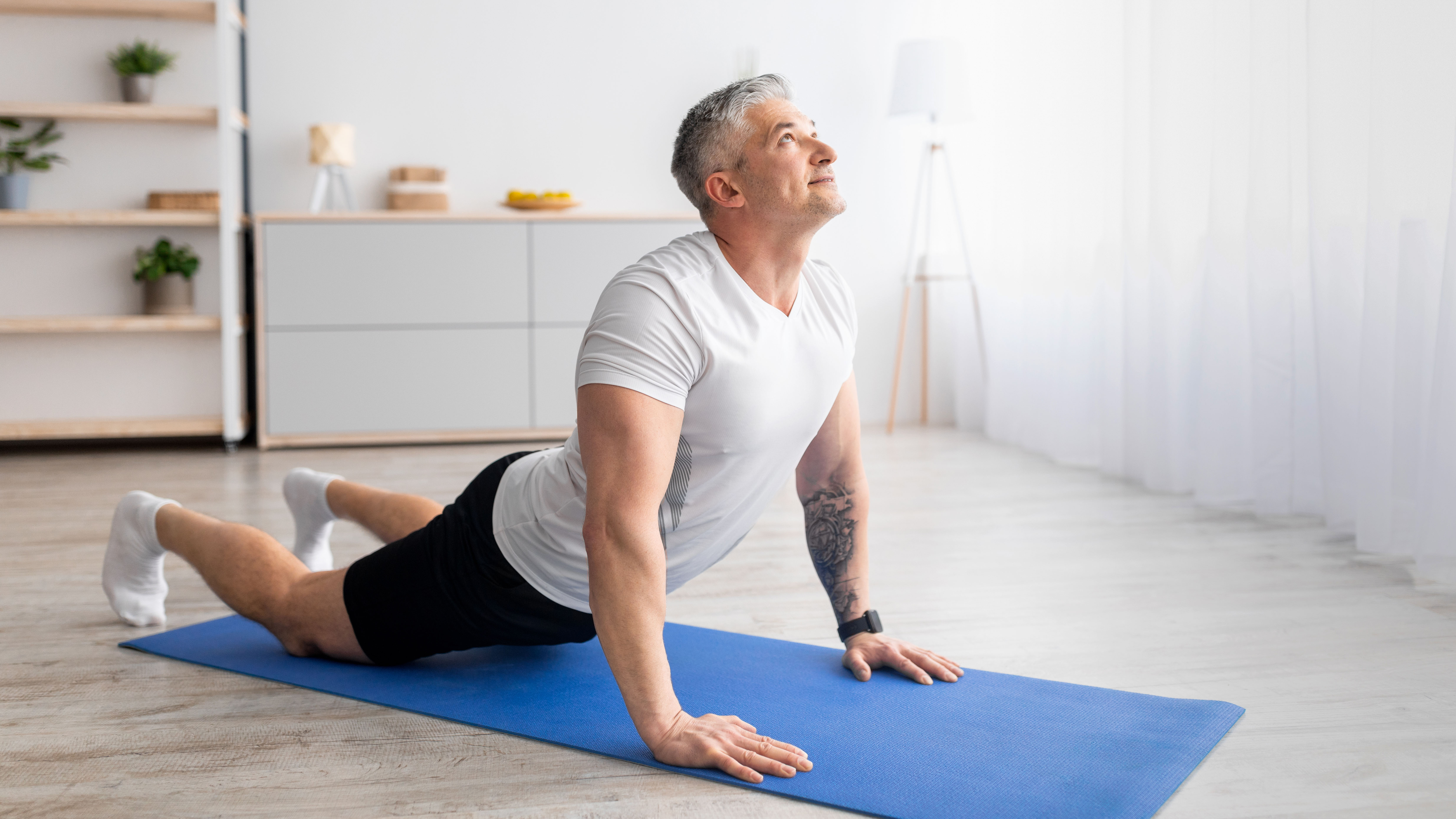 Man practicing yoga at home