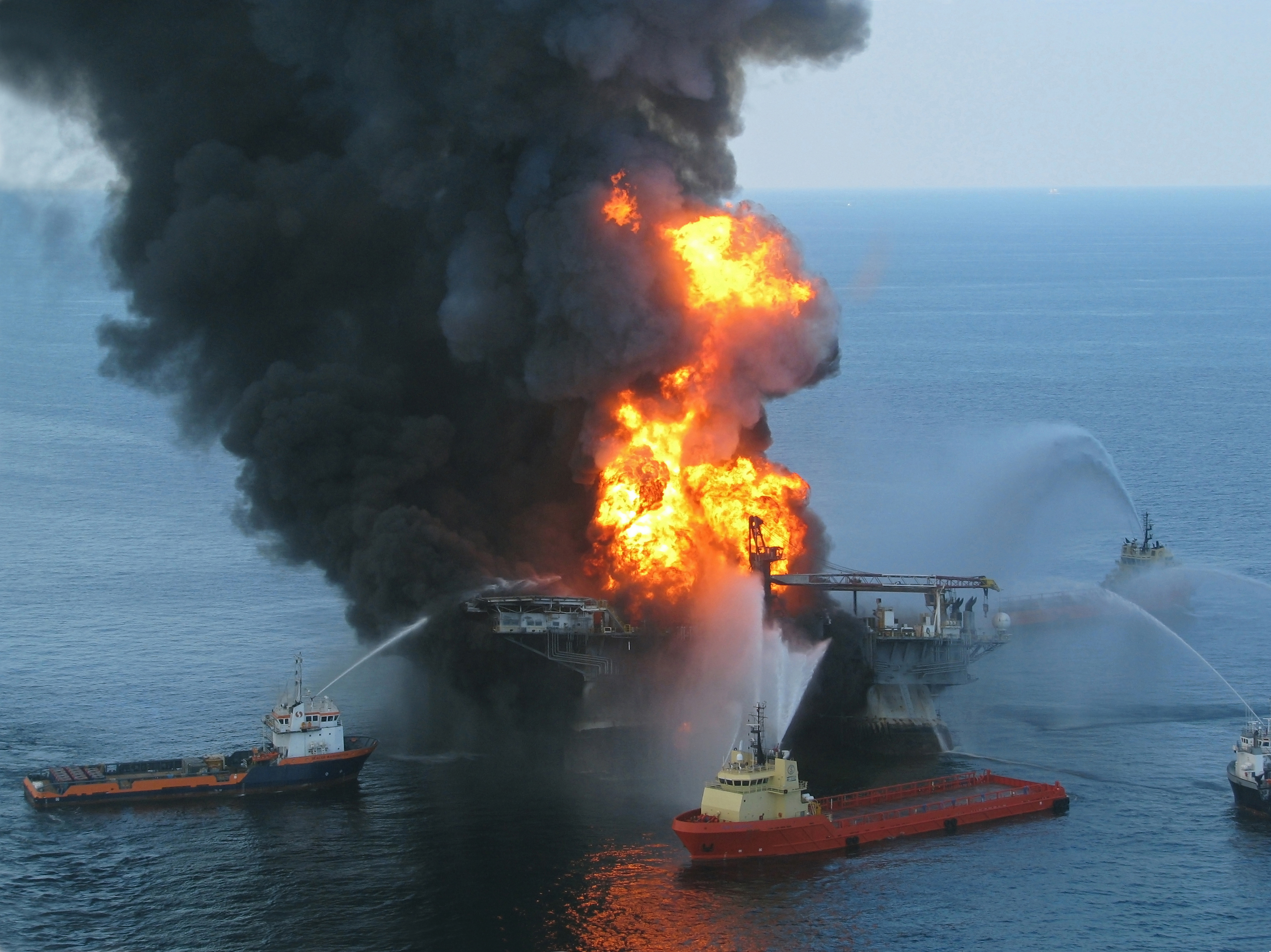 Platform supply vessels battle the blazing remnants of the off shore oil rig Deepwater Horizon. A Coast Guard MH-65C dolphin rescue helicopter and crew document the fire aboard the mobile offshore drilling unit Deepwater Horizon, while searching for survivors. Multiple Coast Guard helicopters, planes and cutters responded to rescue the Deepwater Horizon�s 126 person crew.