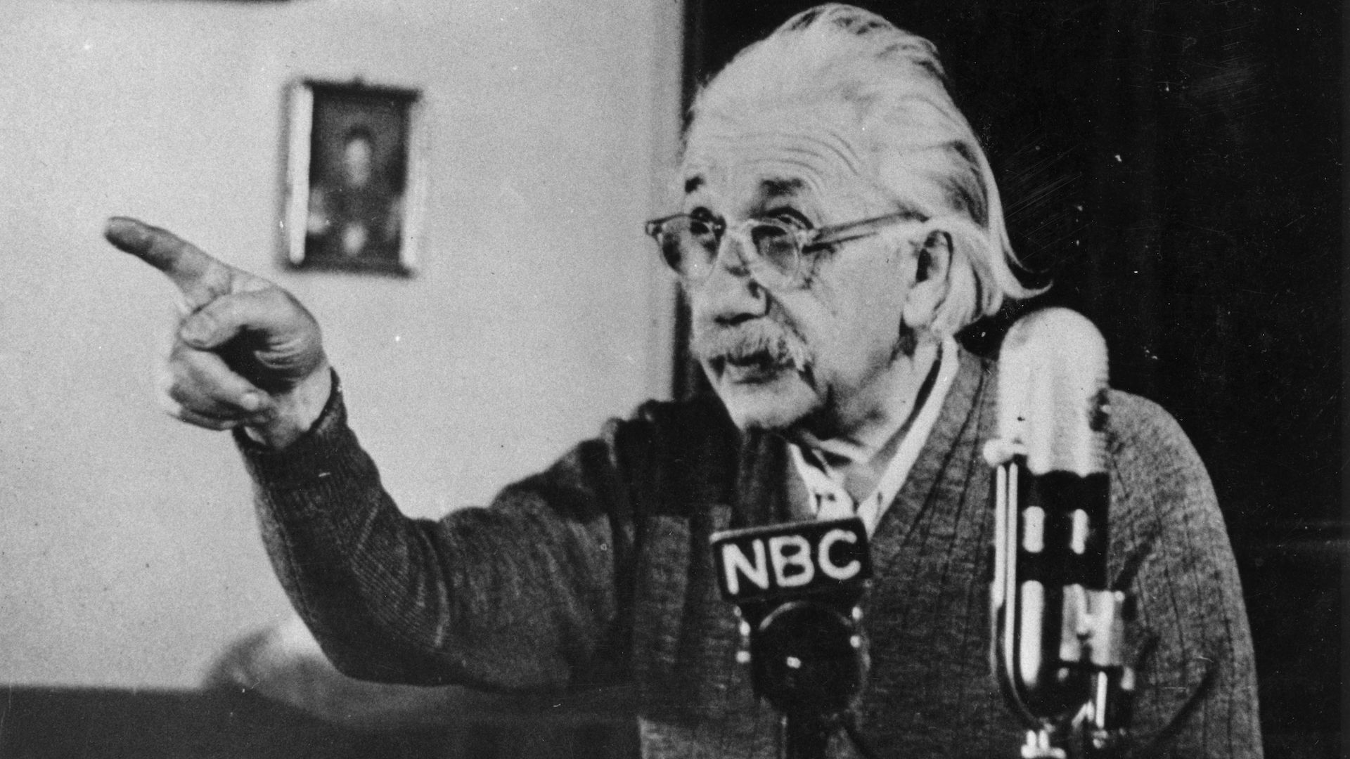 Einstein pointing during a speech