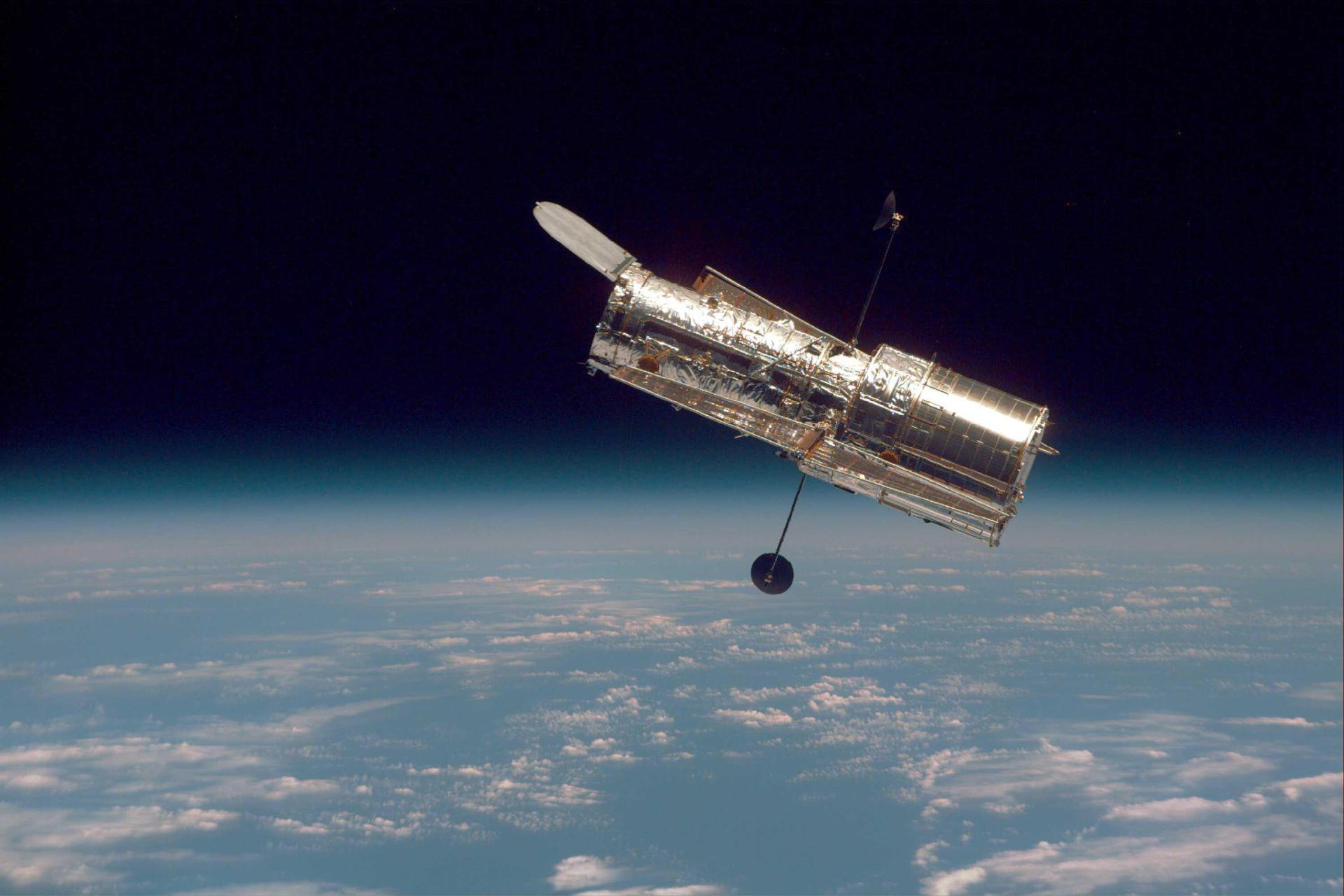 The Hubble Space Telescope drifts above the horizon of the Earth, as it has since 1990.
