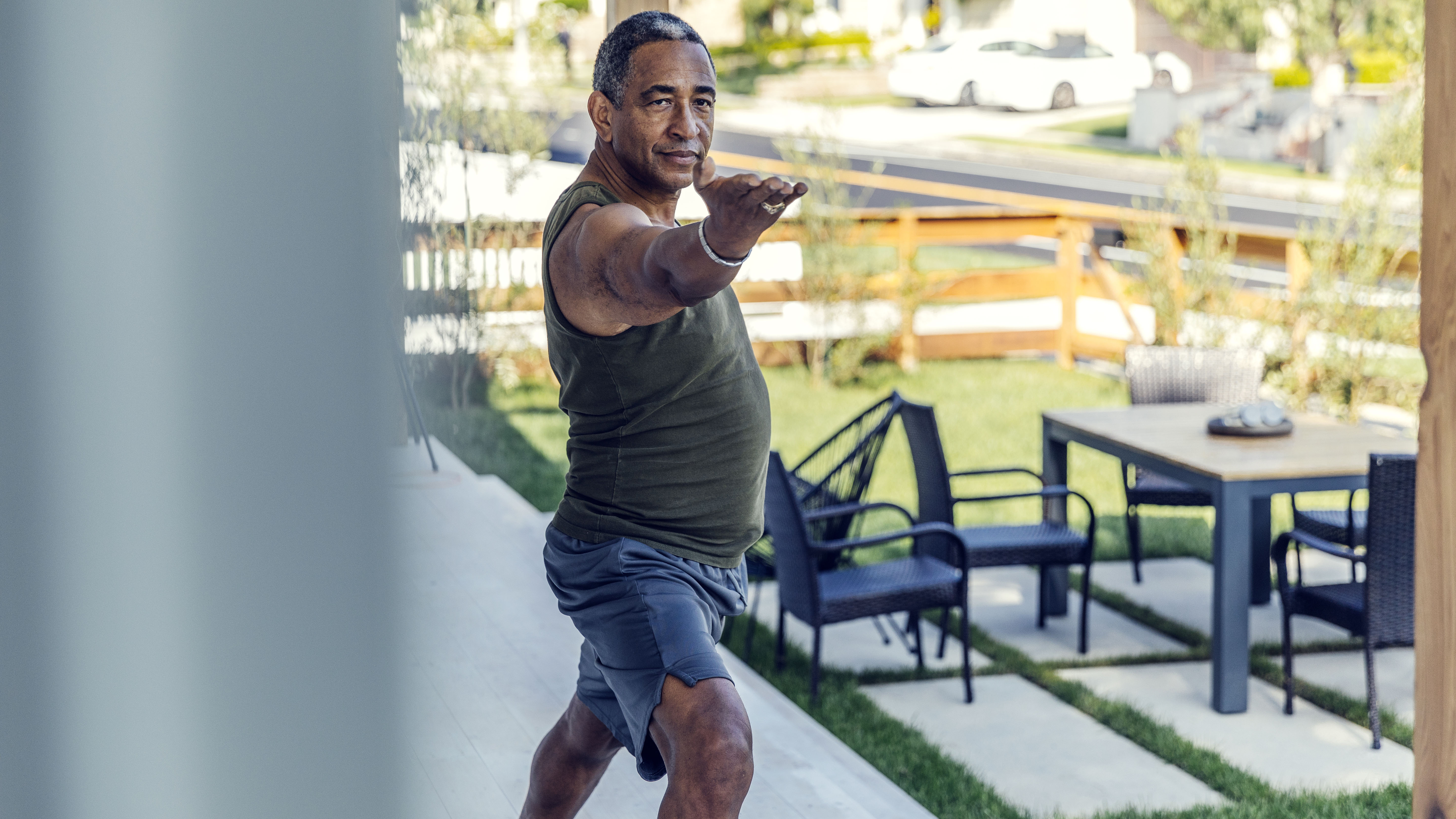 Mature man practicing yoga outside