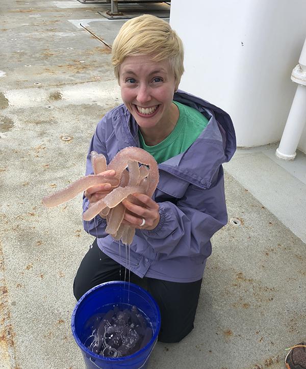 Jessie Masterman, who will be a doctoral student at the Oregon Institute of Marine Biology this fall, shows a double handful of sea pickles.