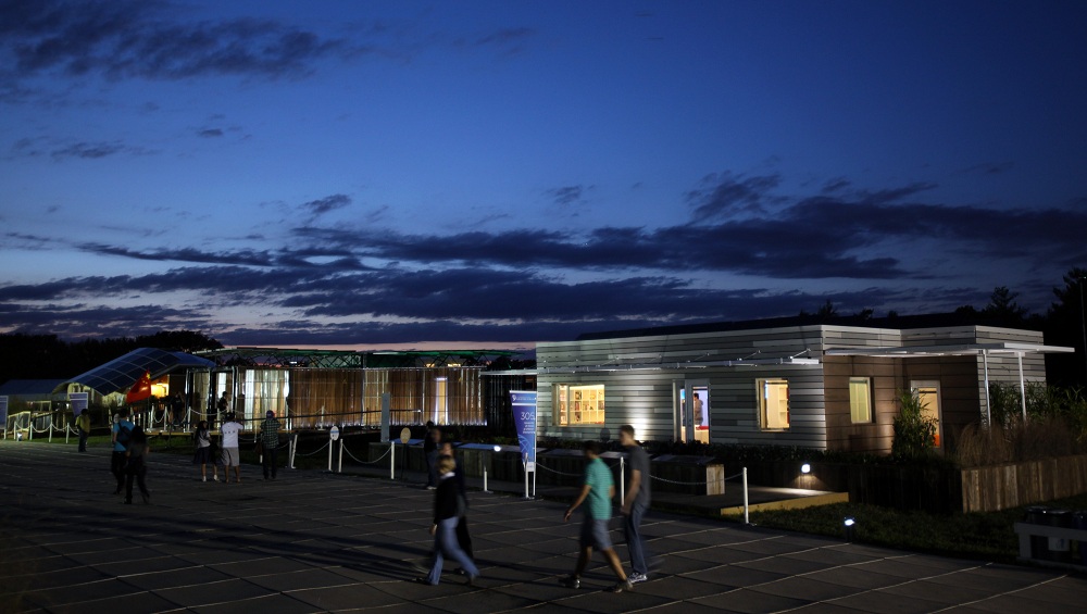 The 300 block of Decathlete Way illuminates with the houses from Canada, Team China and Illinois, from left to right, at the U.S. Department of Energy Solar Decathlon 2011 in Washington, D.C., Sept. 30, 2011.
