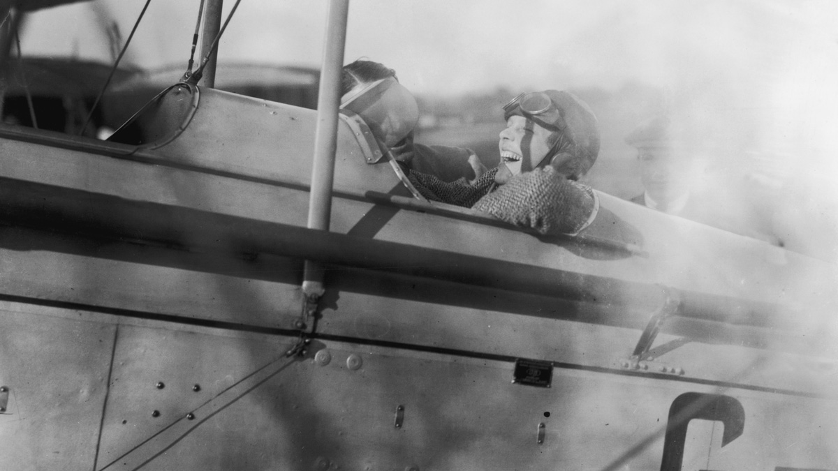 Amelia Earhart laughs with joy during a trip to Northolt in a Moth plane on June 24, 1928.