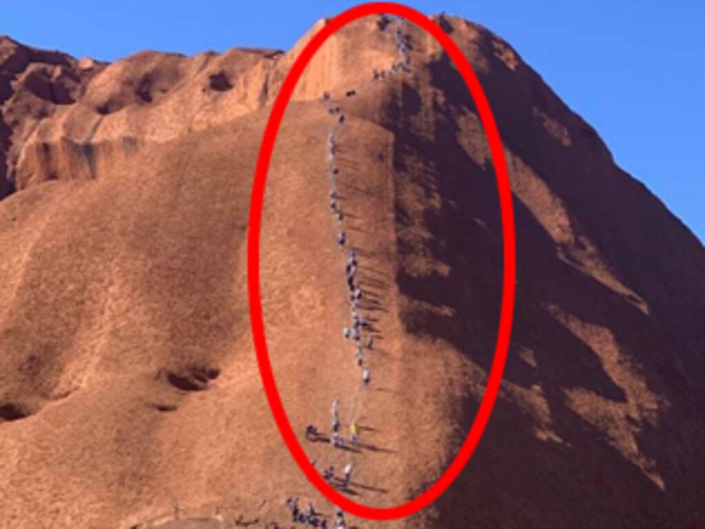 Uluru climbing ban Photo shows tourists climbing Ayers Rock before