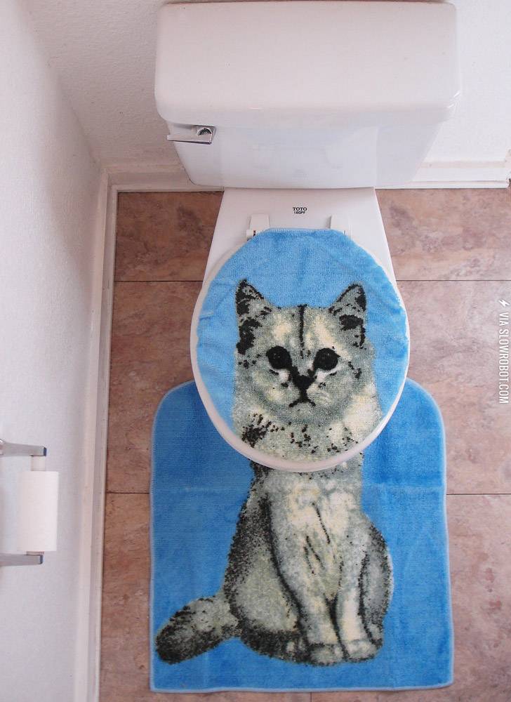 Kitty cat toilet seat cover with rug.