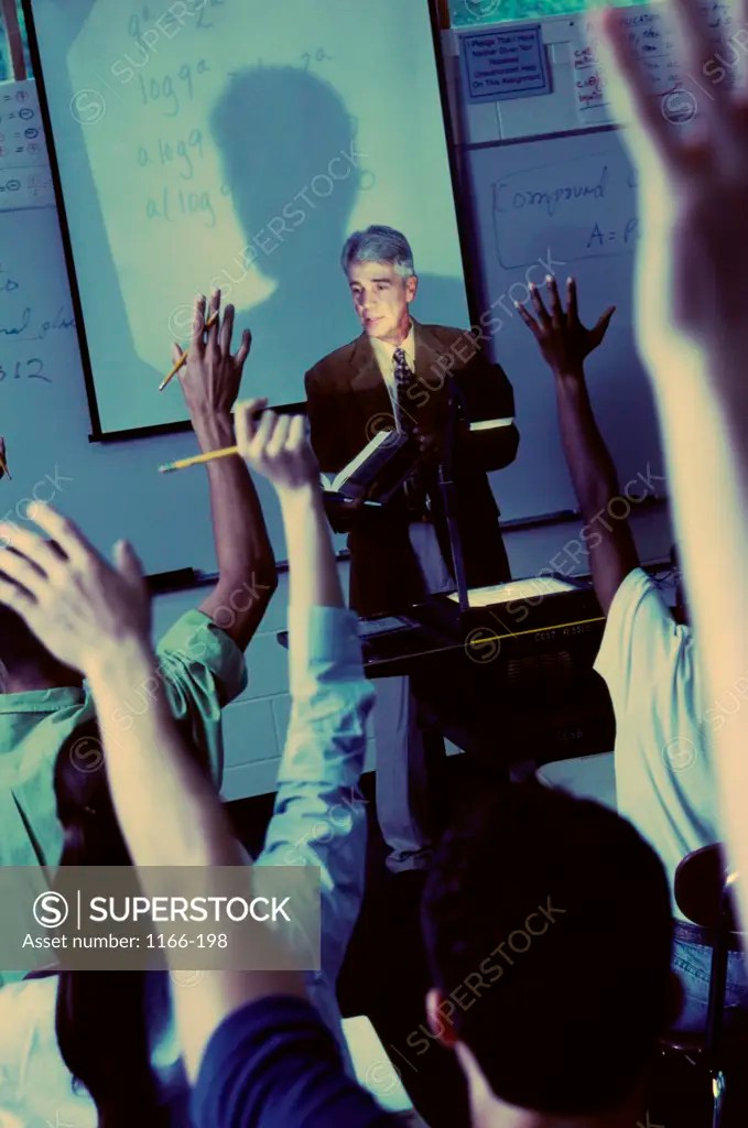 Teacher explaining with the help of an overhead projector SuperStock