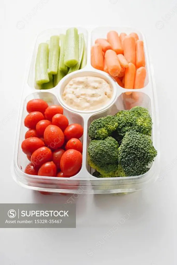 Assorted vegetables with dip in plastic tray SuperStock