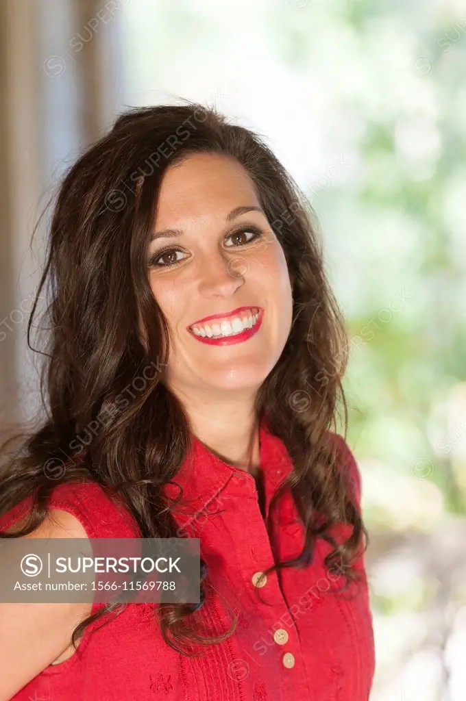 A portrait of a smiling 36 year old woman looking directly at