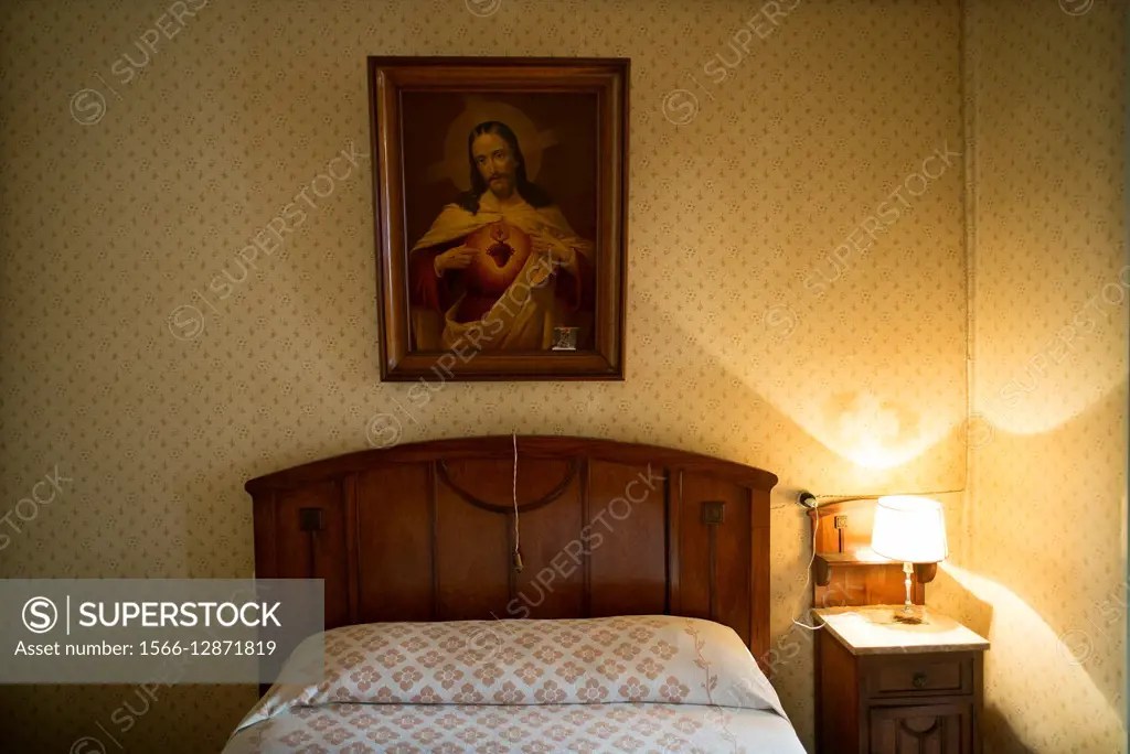 Vintage wall of a bedroom with a picture of the Sacred Heart of Jesus