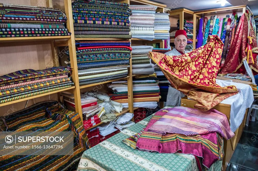 Bilal Abu Khalaf, dealer of imported orient fabrics, shows textiles in
