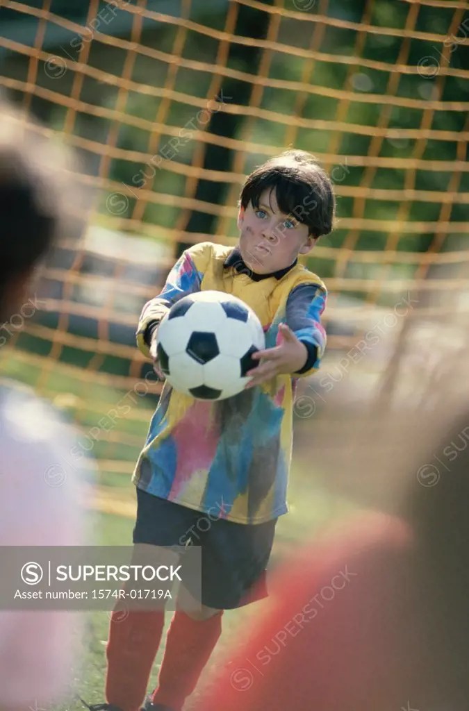 Goalie holding a soccer ball SuperStock