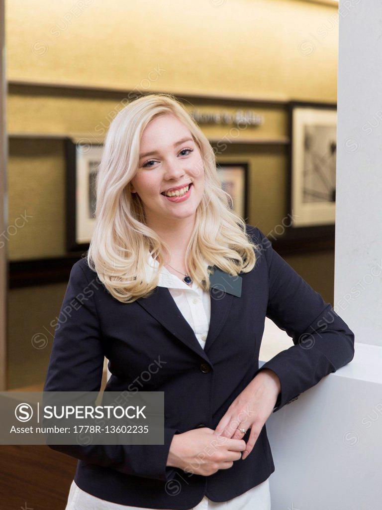Female Housekeeper Staff Stands Against A Wall In A Dallas Hotel SuperStock