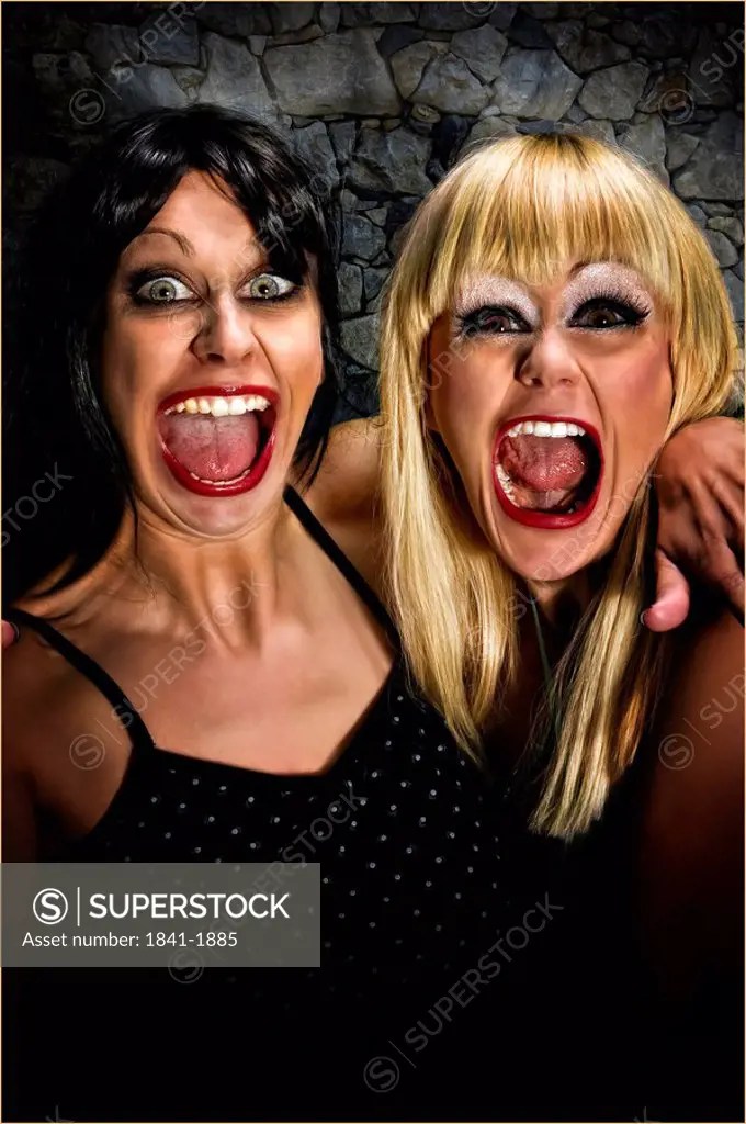 two women with a wide open mouth, portrait SuperStock