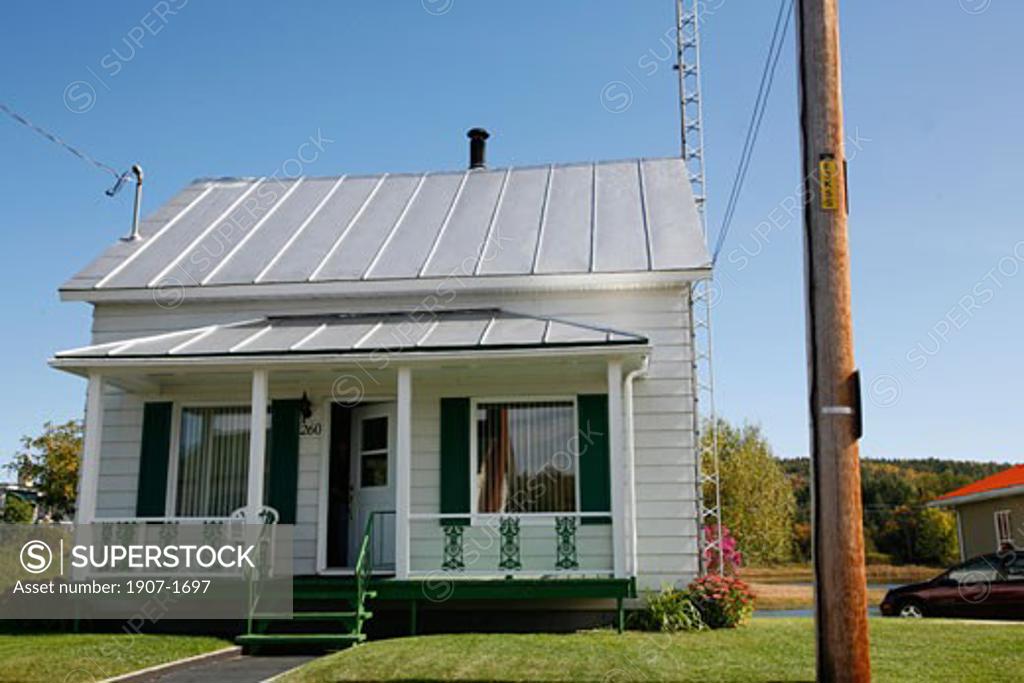 A small wooden house of SaintAlexisdesMonts in the center of the