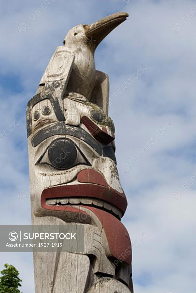Totem Pole closeup showing Giant Woodpecker on top Museum of