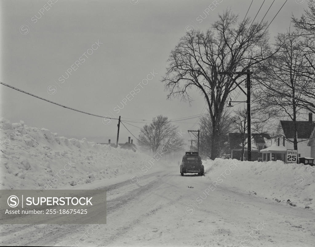 Vintage photograph. Car on road, winter scene in Gorham, New Hampshire