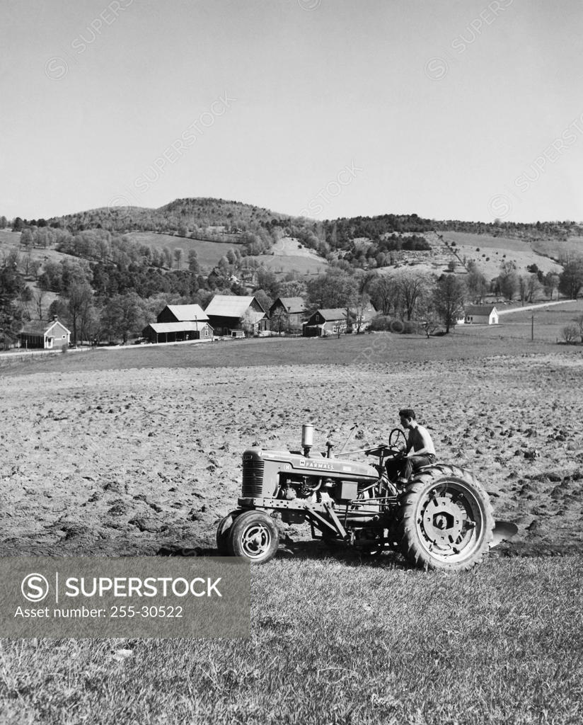 Farmer plowing a field with a tractor, Hartford, Vermont, USA SuperStock