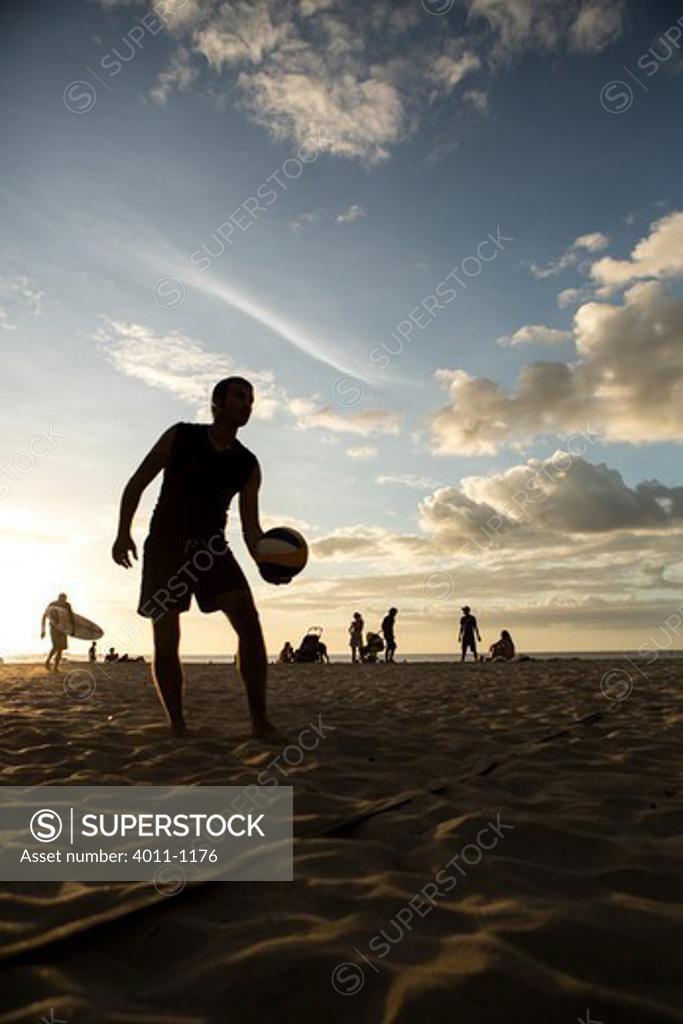 Man playing beach volleyball on the beach, Costa Rica SuperStock