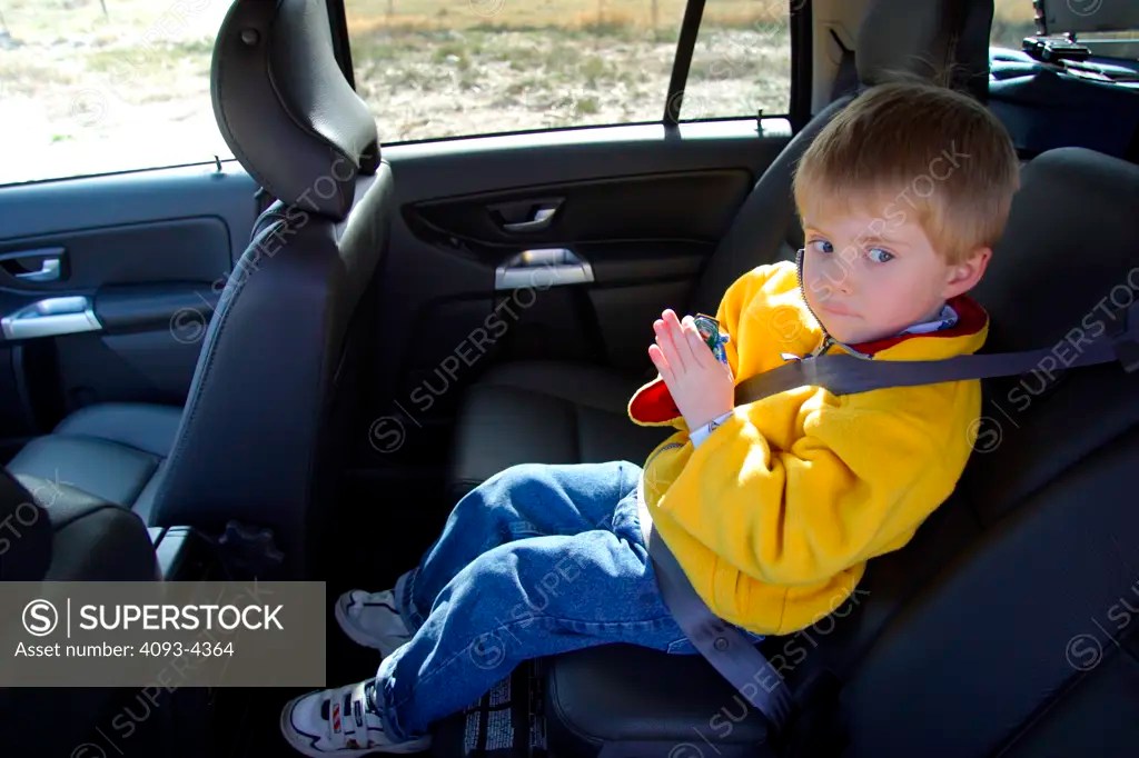 interior Volvo XC90 2005 child kid boy black leather seats SuperStock