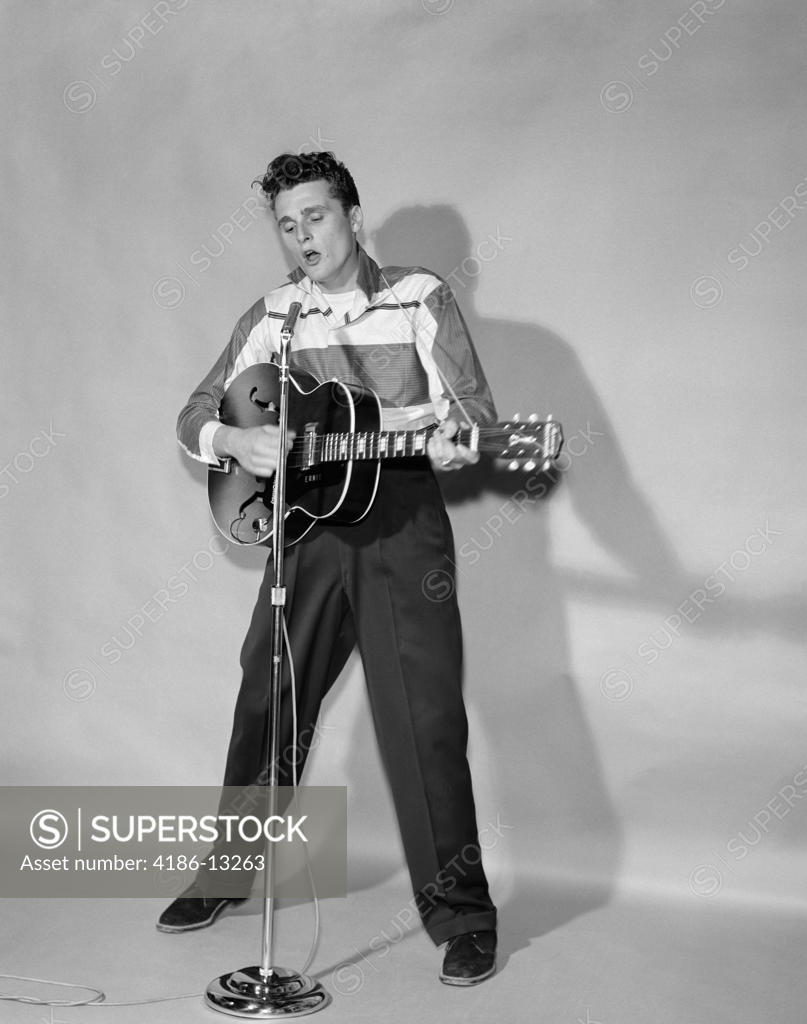 1950S Rockabilly Singer In Front Of Microphone Strumming HollowBody