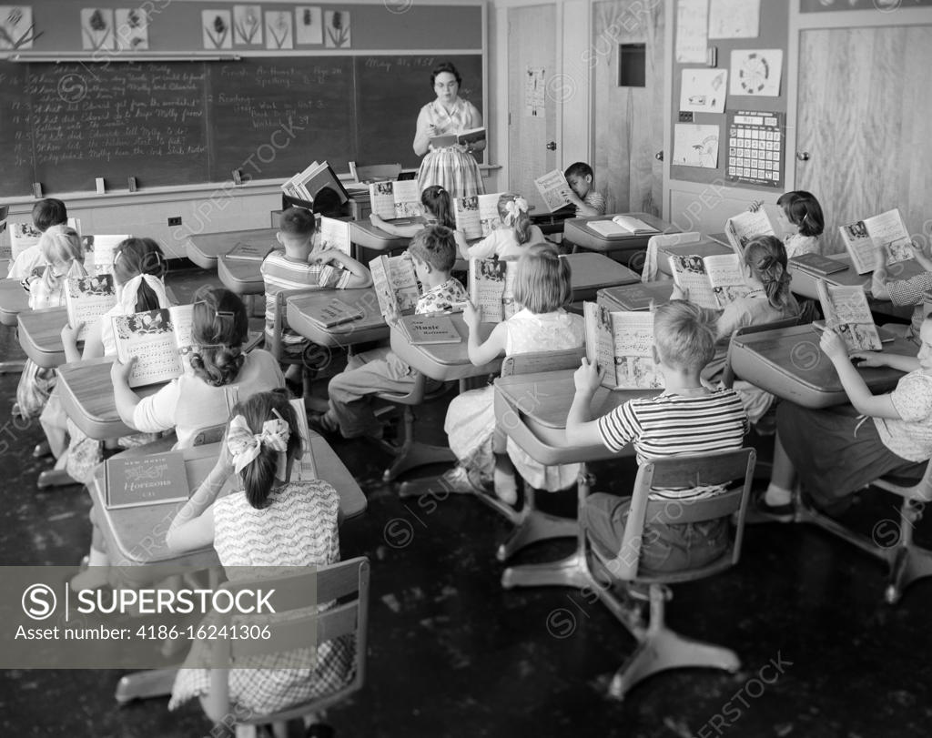 1950s 1960s ELEMENTARY SCHOOL CLASSROOM TEACHER WOMAN AND STUDENTS