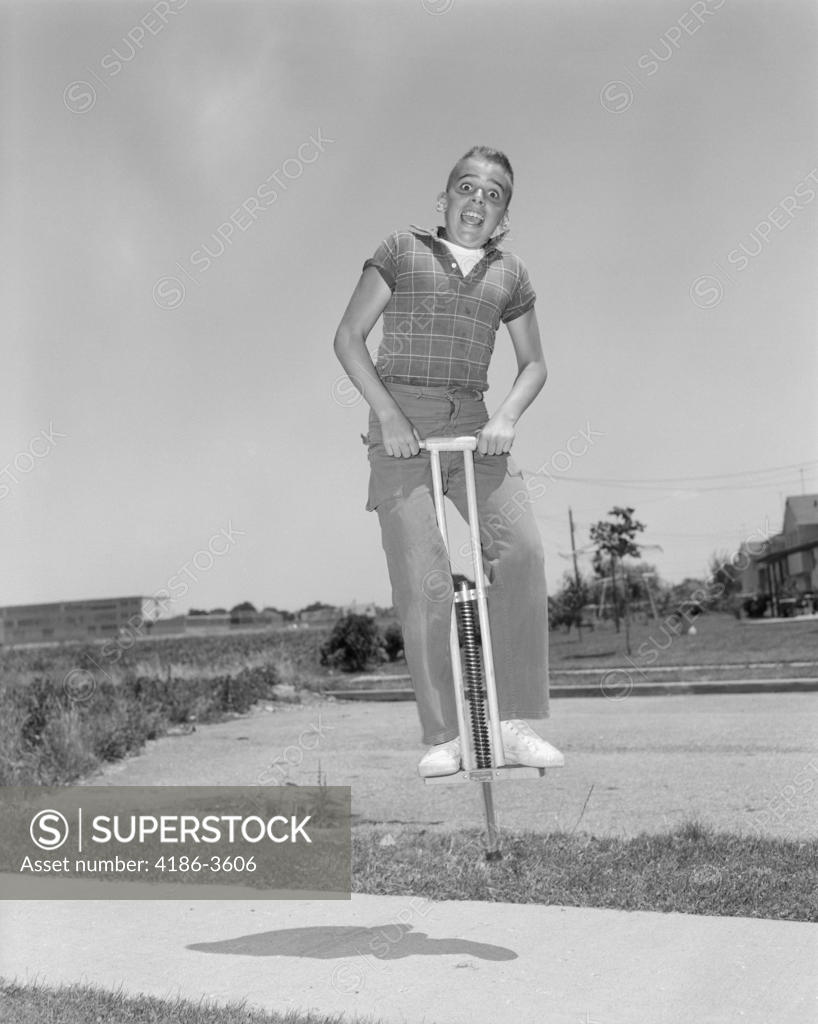 1950S Boy Jumping On Pogo Stick SuperStock