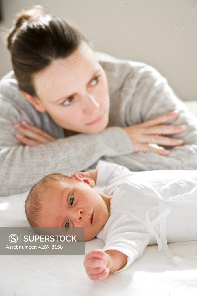 3 weeks old baby with his mother. SuperStock