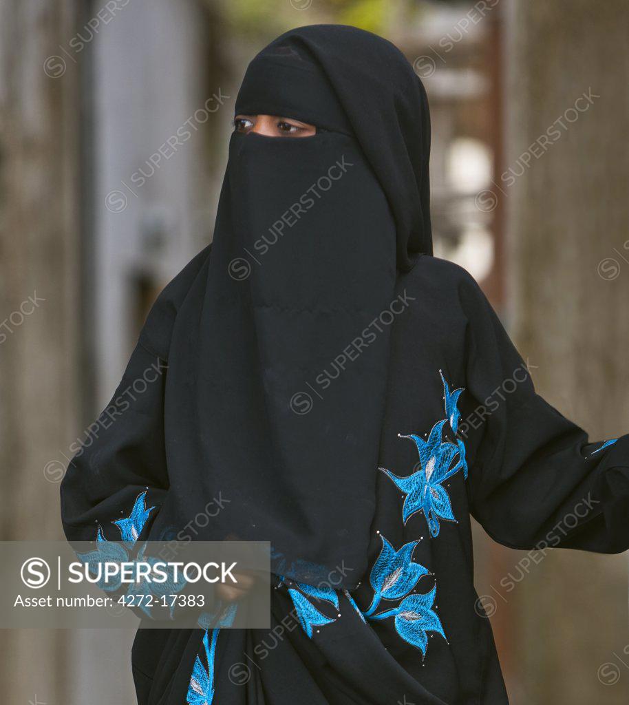 Kenya, Lamu Island, Lamu. A Muslim woman of Lamu town wearing a buibui