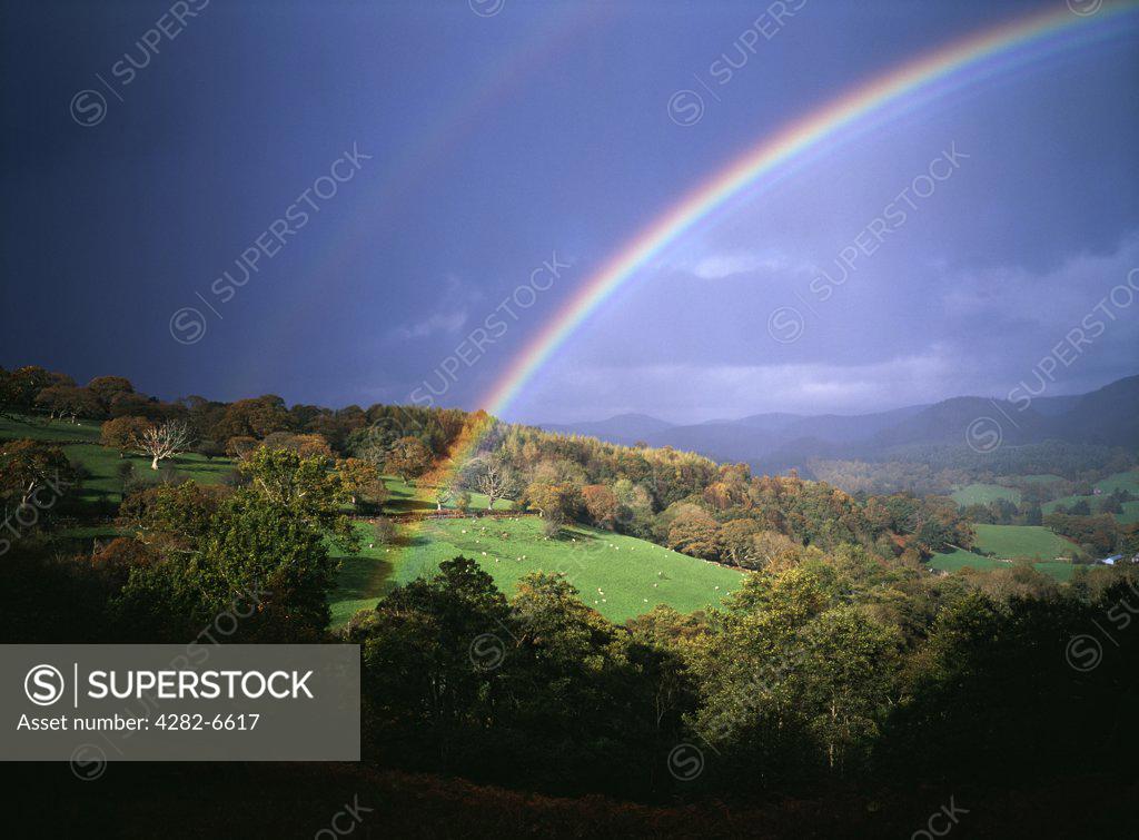 Wales, Denbighshire, Near Llangollen. Storm light with rainbow against