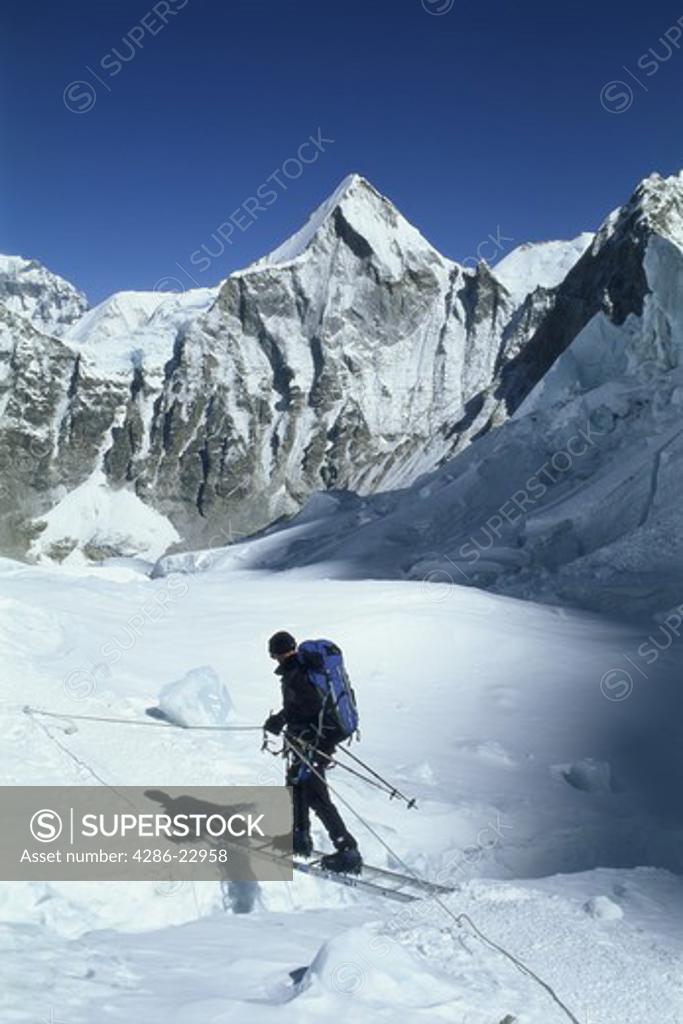 Crossing a crevasse on Mount Everest in the Khumbu Icefall SuperStock