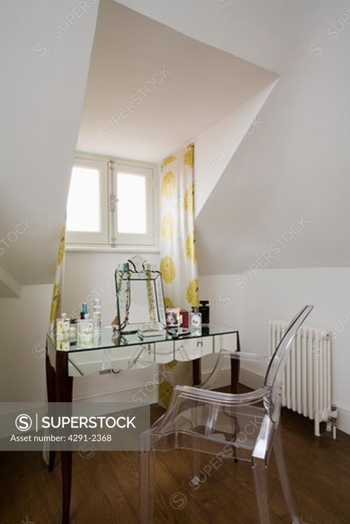 Philippe Starck perspex Ghost chair at mirrored dressing table in attic