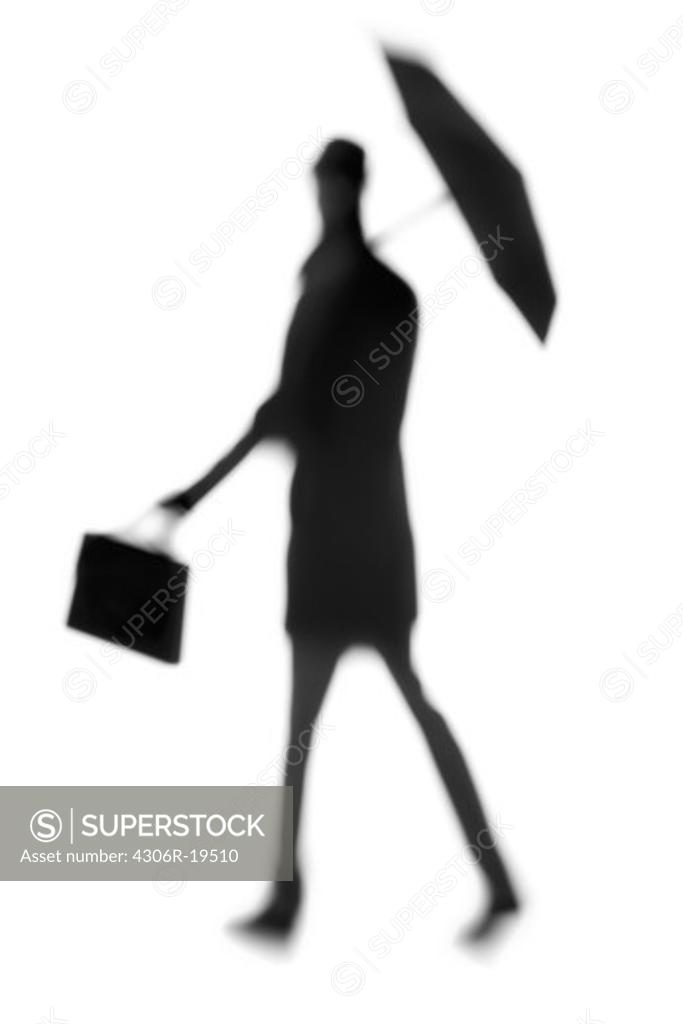 Silhouette of a man with an umbrella. SuperStock