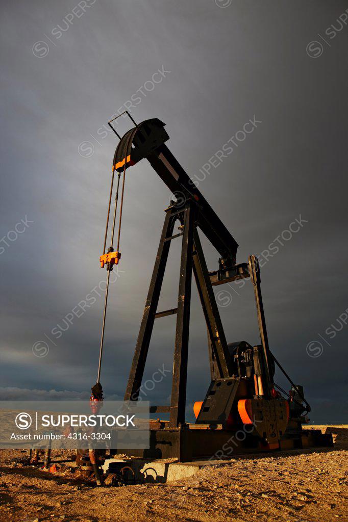 An oil well pump jack in northeastern Colorado. A pump jack is also known as a pumpjack, a