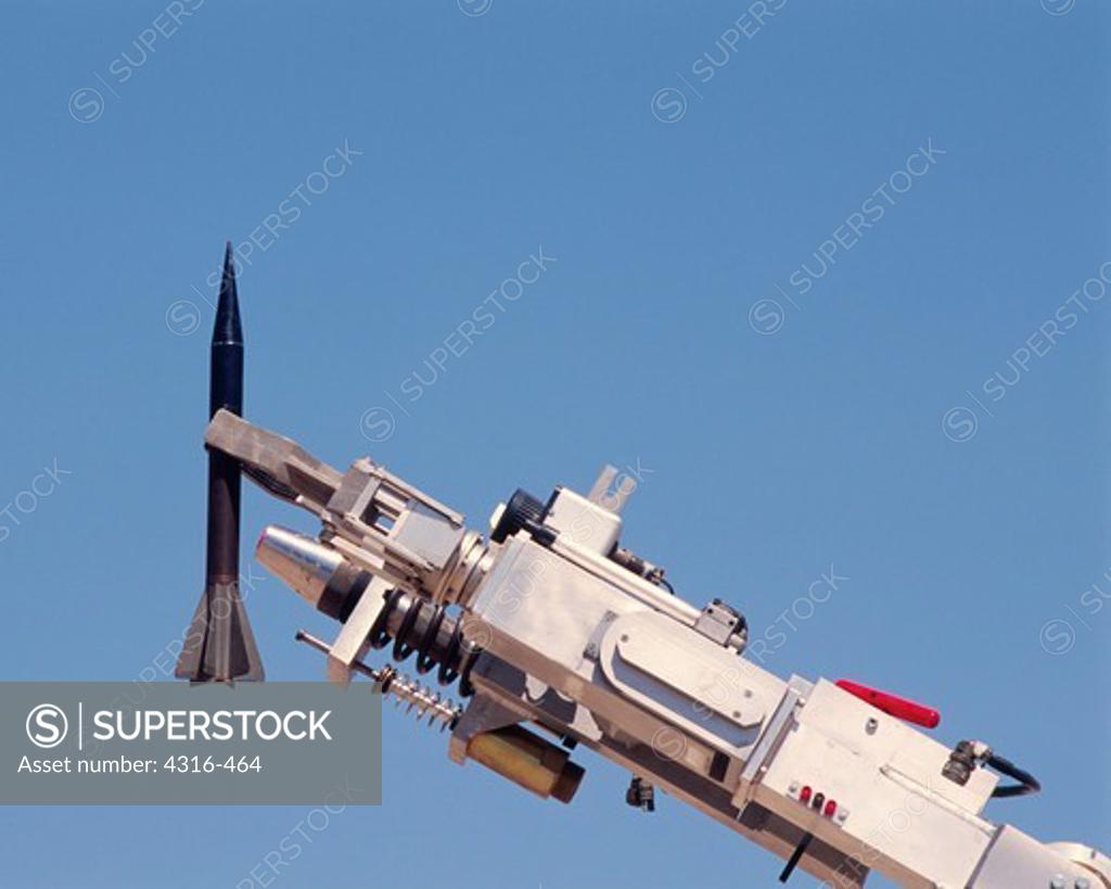 An Explosive Ordnance Disposal Robot Grips a Depleted Uranium Sabot