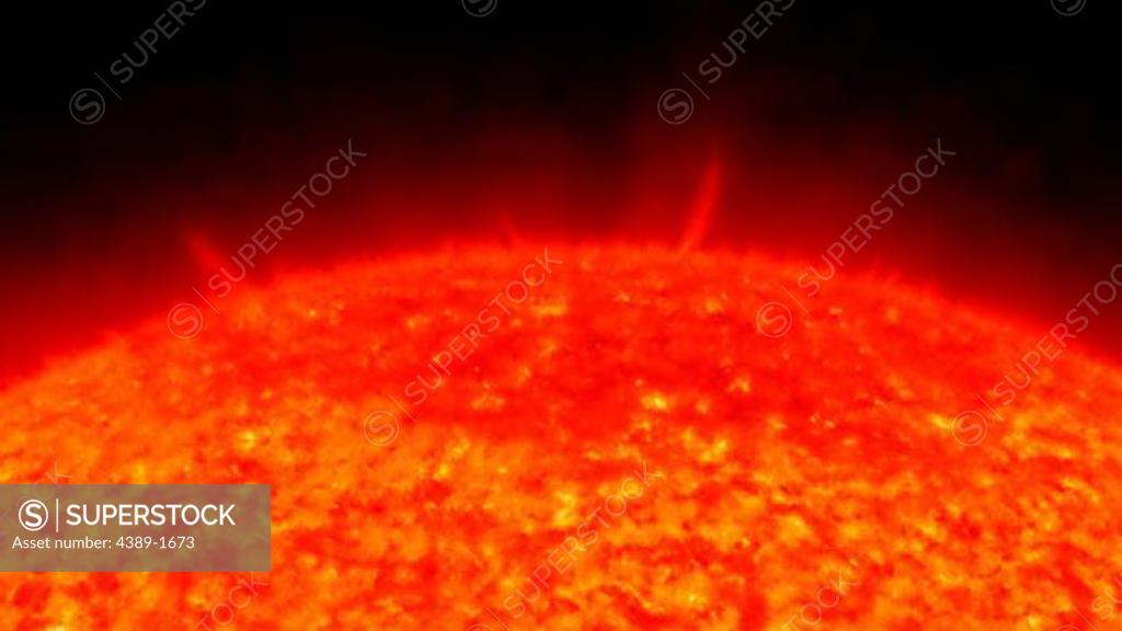 A close up view of the top of the Sun as seen in profile shows thousands of little spurts, like