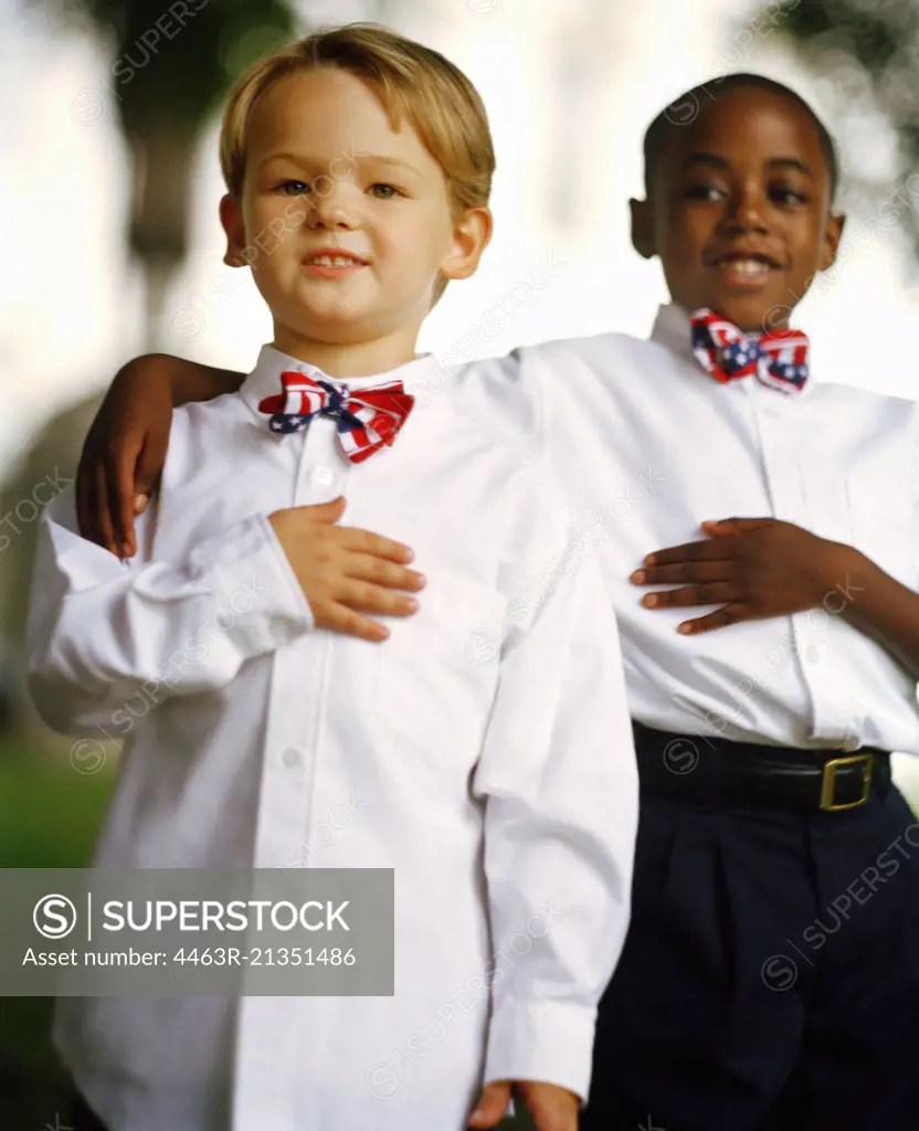 Two boys wearing stars and stripes bow ties SuperStock