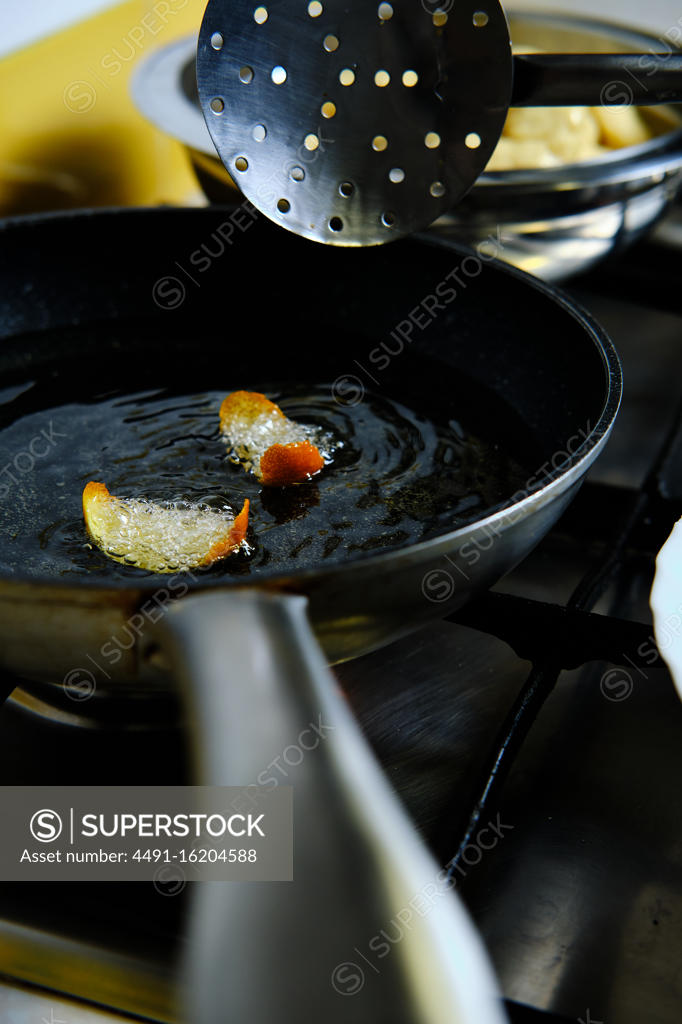 From above bunch of delicious doughnuts frying in hot bubbling oil on