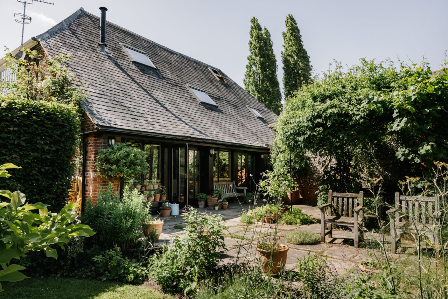 This converted coach house sleeps 10 under original wood beams The Spaces
