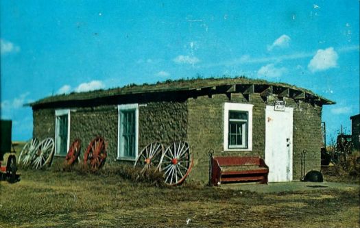 Solve odd bulildings Old Sod House School Colby Kansas Postcard jigsaw