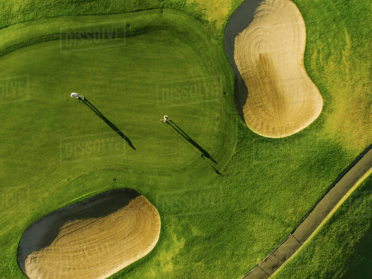 Golf course top view with players. Aerial view of golfers on putting