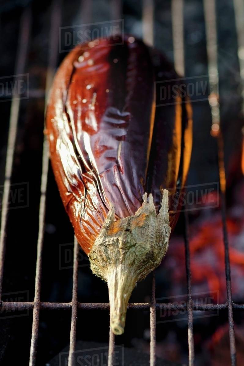 A whole aubergine on a barbecue Stock Photo Dissolve
